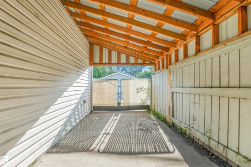 Covered outdoor passage with exposed wood beams, concrete flooring, and horizontal siding - 12209 94 Street Nw, Edmonton, AB -  Photo Showing Other Room