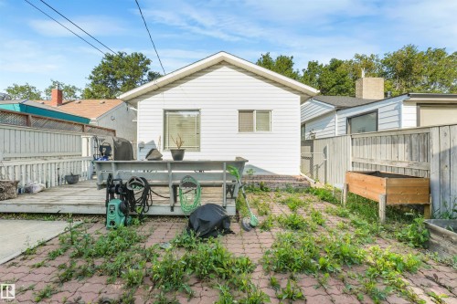 Exterior with white horizontal siding and a wooden deck - 12209 94 Street Nw, Edmonton, AB - Outdoor With Exterior
