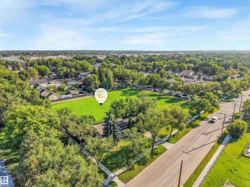 Expansive green space and mature trees within a developed neighborhood - 12209 94 Street Nw, Edmonton, AB - Outdoor With View