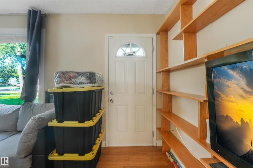 Wood-finish flooring throughout - 12209 94 Street Nw, Edmonton, AB - Indoor Photo Showing Other Room