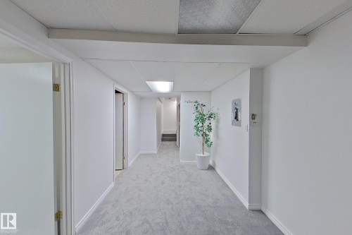 Recessed ceiling lighting illuminates the plush gray carpeting - #7 16823 84 St Nw Nw, Edmonton, AB - Indoor Photo Showing Other Room