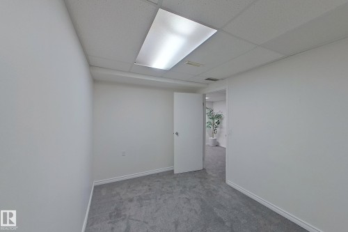 Recessed fluorescent lighting, white drop ceiling, light gray carpeting, and white painted walls - #7 16823 84 St Nw Nw, Edmonton, AB - Indoor Photo Showing Other Room
