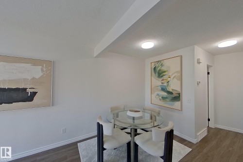 Recessed lighting fixtures, wood-finish flooring, white baseboards, and a white ceiling - #7 16823 84 St Nw Nw, Edmonton, AB - Indoor Photo Showing Dining Room