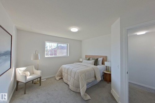 Carpeted room with a window, white walls, and a flush-mount ceiling light - #7 16823 84 St Nw Nw, Edmonton, AB - Indoor Photo Showing Bedroom