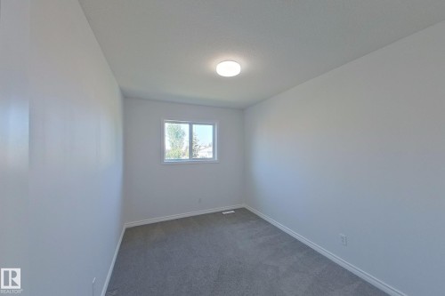 Neutral wall finishes, recessed window, and flush mount ceiling light - #7 16823 84 St Nw Nw, Edmonton, AB - Indoor Photo Showing Other Room