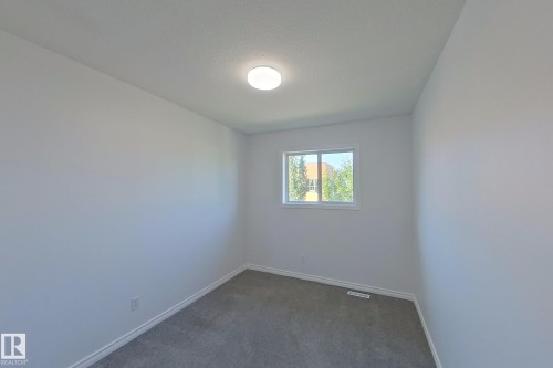 Recessed lighting, light gray carpeting, and neutral wall tones - #7 16823 84 St Nw Nw, Edmonton, AB - Indoor Photo Showing Other Room