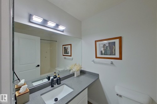 Vanity featuring a rectangular undermount sink, matte black faucet, and grey countertop - #7 16823 84 St Nw Nw, Edmonton, AB - Indoor Photo Showing Bathroom