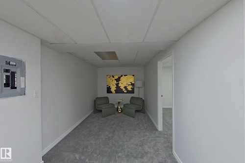 Recessed lighting, drop ceiling, wall-to-wall carpeting, white walls, electrical panel - #7 16823 84 St Nw Nw, Edmonton, AB - Indoor Photo Showing Other Room