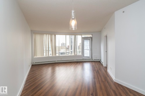 Expansive windows with vertical blinds - #1004 10136 104 St Nw, Edmonton, AB - Indoor Photo Showing Other Room