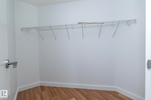 Closet space featuring wood-finish flooring and integrated wire shelving - #1004 10136 104 St Nw, Edmonton, AB - Indoor With Storage