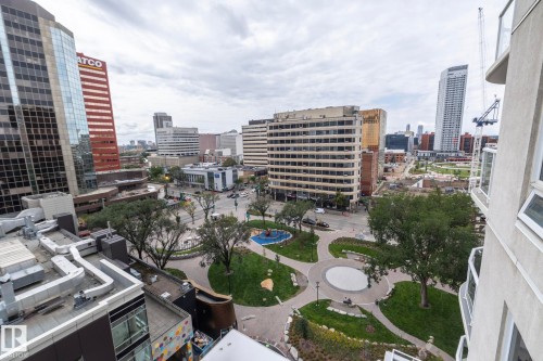 Urban skyline with varied architectural styles, including contemporary glass-fronted buildings and a park with walking paths - #1004 10136 104 St Nw, Edmonton, AB - Outdoor With View