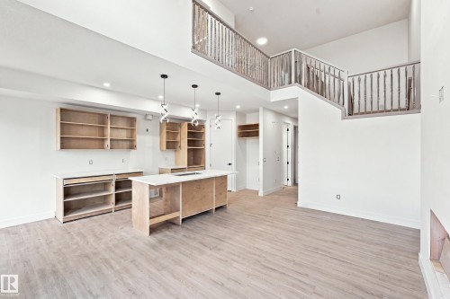 Vaulted ceilings, open concept design, light wood-finish flooring, two-story layout, and recessed lighting - 1818 155 Avenue Nw, Edmonton, AB - Indoor Photo Showing Other Room