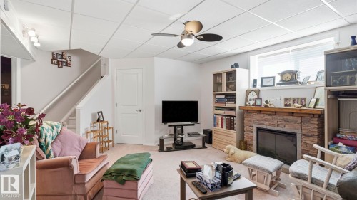 50 Snowbird Crescent, Leduc, AB - Indoor Photo Showing Other Room With Fireplace