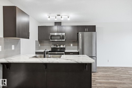 #424 5515 7 Av Sw, Edmonton, AB - Indoor Photo Showing Kitchen With Stainless Steel Kitchen With Double Sink With Upgraded Kitchen