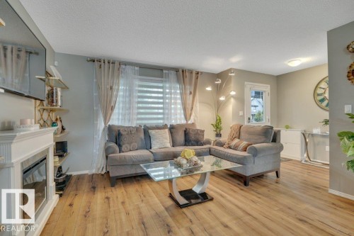 723 Secord Boulevard Nw, Edmonton, AB - Indoor Photo Showing Living Room With Fireplace