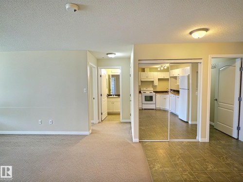 Open-concept living space with carpeted flooring - #111 5350 199 St Nw, Edmonton, AB - Indoor Photo Showing Other Room
