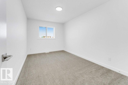 Neutral wall palette, window with white trim, recessed ceiling light, and gray carpet flooring - 182 Pacific Drive, Spruce Grove, AB - Indoor Photo Showing Other Room