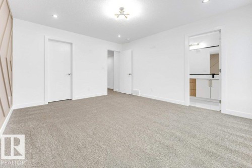 Spacious room with plush carpeting, recessed lighting, and a modern ceiling fixture - 182 Pacific Drive, Spruce Grove, AB - Indoor Photo Showing Other Room