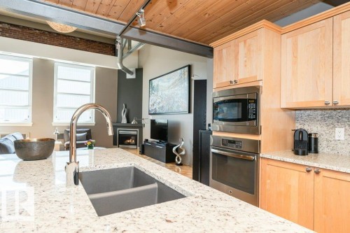 #203 10009 102 Av Nw, Edmonton, AB - Indoor Photo Showing Kitchen With Stainless Steel Kitchen With Double Sink With Upgraded Kitchen