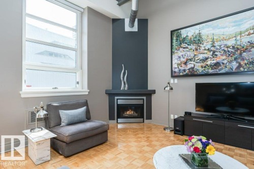 #203 10009 102 Av Nw, Edmonton, AB - Indoor Photo Showing Living Room With Fireplace