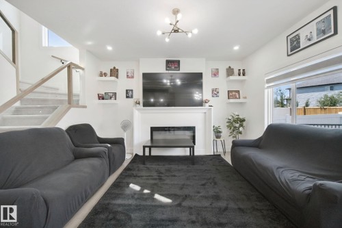 White interior walls with recessed lighting - 4820 174 Avenue Nw, Edmonton, AB - Indoor Photo Showing Living Room With Fireplace