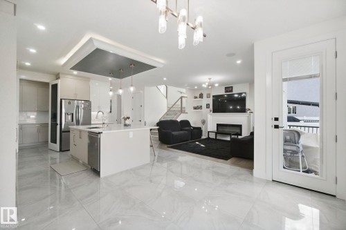 Spacious kitchen with a large island, stainless steel appliances, and pendant lighting - 4820 174 Avenue Nw, Edmonton, AB - Indoor Photo Showing Kitchen