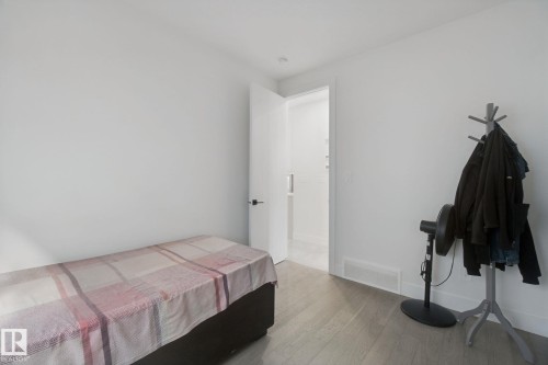 Wood-finish flooring, white walls, and a recessed ceiling light - 4820 174 Avenue Nw, Edmonton, AB - Indoor Photo Showing Bedroom