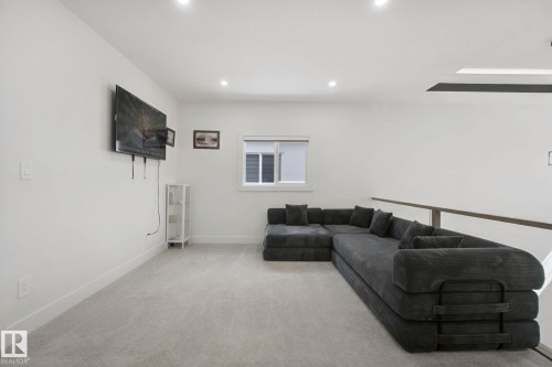 Recessed lighting, light-colored carpeting, and a window with horizontal blinds - 4820 174 Avenue Nw, Edmonton, AB - Indoor