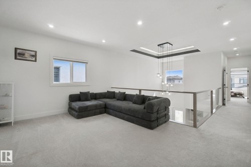 Recessed lighting, light gray carpeting, and a glass-paneled railing - 4820 174 Avenue Nw, Edmonton, AB - Indoor