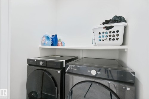 Built-in shelving for storage - 4820 174 Avenue Nw, Edmonton, AB - Indoor Photo Showing Laundry Room