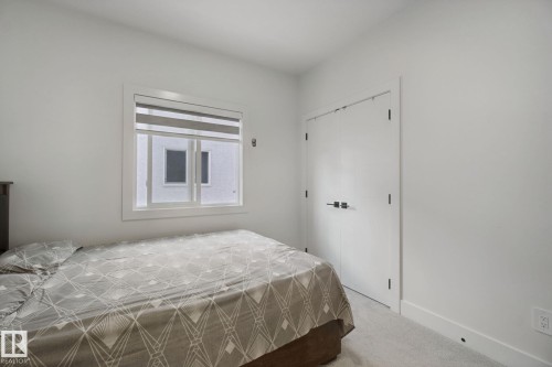 White walls and ceiling, white trim, light-toned carpeting, and a window with blinds - 4820 174 Avenue Nw, Edmonton, AB - Indoor Photo Showing Bedroom