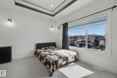 Coved ceiling with black accent trim, recessed lighting, and twin wall sconces - 4820 174 Avenue Nw, Edmonton, AB - Indoor Photo Showing Bedroom