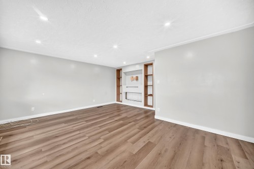 Recessed lighting, crown molding, wood-finish flooring, and built-in shelving - 7603 130 Avenue Nw, Edmonton, AB - Indoor Photo Showing Other Room