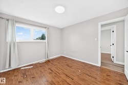 Wood-finish flooring with light-toned walls and a flush-mount ceiling light - 