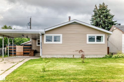 Exterior featuring horizontal siding and white-framed windows - 7603 130 Avenue Nw, Edmonton, AB - Outdoor