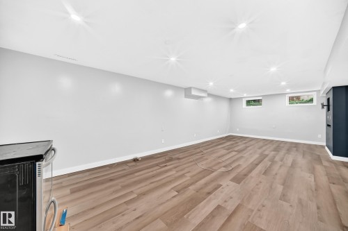 Recessed lighting, wood-finish flooring, light gray wall paint, and two windows - 7603 130 Avenue Nw, Edmonton, AB - Indoor
