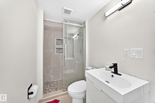 Modern vanity with an integrated sink and matte black faucet - 7603 130 Avenue Nw, Edmonton, AB - Indoor Photo Showing Bathroom
