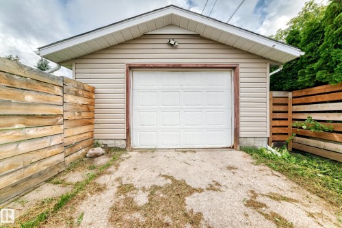 Detached garage with horizontal vinyl siding and a panel-style overhead door - 7603 130 Avenue Nw, Edmonton, AB - Outdoor With Exterior