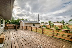 Expansive wooden deck with slatted wood railings - 
