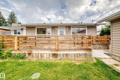 Wood deck with horizontal railing, siding exterior, and multiple windows - 7603 130 Avenue Nw, Edmonton, AB - Outdoor With Deck Patio Veranda