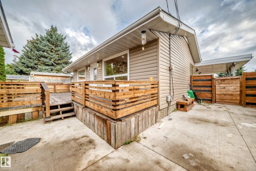 Exterior featuring horizontal siding, a private wood deck with railing, and a concrete patio - 7603 130 Avenue Nw, Edmonton, AB - Outdoor