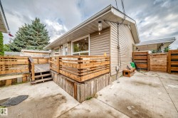 Exterior featuring horizontal siding, a private wood deck with railing, and a concrete patio - 
