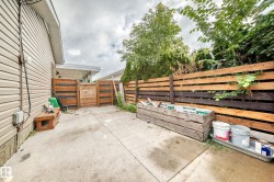 Poured concrete patio with a two-tone horizontal wood fence and natural wood privacy screens - 