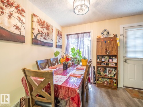 Wood-finish flooring with a ceiling-mounted light fixture, recessed window, and white door - #No 510 Abbottsfield Rd Nw Nw, Edmonton, AB - Indoor Photo Showing Dining Room