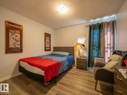 Wood-finish flooring with a neutral wall color and ceiling-mounted light fixture - 