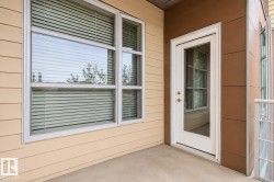 Private balcony featuring a full-light door, expansive window, and durable exterior siding - 