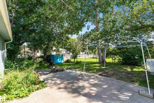Concrete patio area surrounded by established trees and landscaping - 5404 45 Avenue, Wetaskiwin, AB - Outdoor