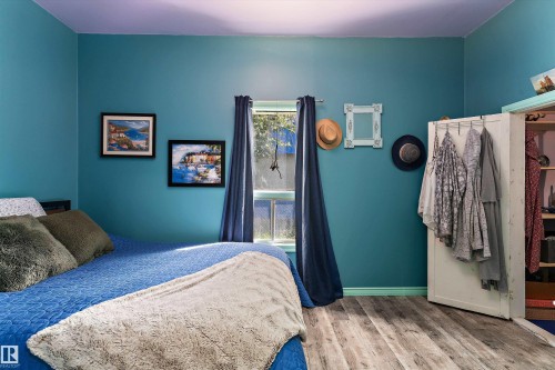 Wood-finish flooring throughout - 5404 45 Avenue, Wetaskiwin, AB - Indoor Photo Showing Bedroom