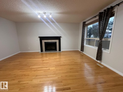 1569 37A Avenue Northwest, Edmonton, AB - Indoor Photo Showing Other Room With Fireplace