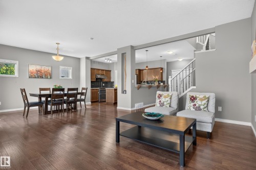 Hardwood-finish flooring throughout, recessed lighting, and a chandelier in the dining area - 9515 221 Street Nw, Edmonton, AB - Indoor Photo Showing Other Room